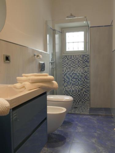 a bathroom with a sink and a toilet and a shower at Andrea Appartamenti in Savona