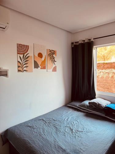 a bedroom with a bed and a window at Aconchego Atalaia in Luis Correia