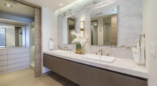 a bathroom with two sinks and two mirrors at Sonoran Star Signature 3-Bedroom Beachfront Luxury Condominium in Puerto Peñasco