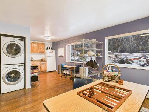 a kitchen and living room with a washer and dryer at Large Juneau Loft w Full Kitchen, WD & Workspace in Juneau