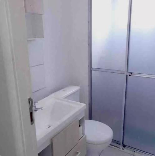 a white bathroom with a toilet and a shower at Canoas Ulbra Parkshopping in Canoas