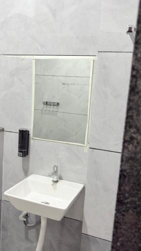 a bathroom with a sink and a mirror at Platform 9 3by4 in Ujjain