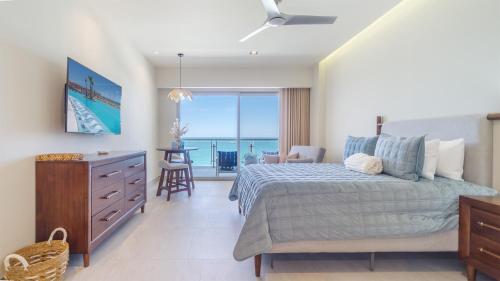 a bedroom with a bed and a view of the ocean at Luxury Oceanfront Condo with Stunning Views in Puerto Peñasco