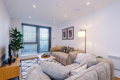 a living room with a couch and a table at Leeds Lux Apartment - 2 Bed & Pool Table, Secure Parking in Leeds