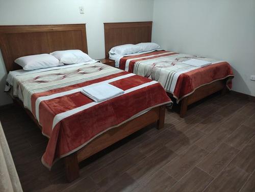 two beds sitting next to each other in a room at Posada Terra Santa in Tequisquiapan
