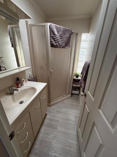 a bathroom with a sink and a mirror at Sunsets over Unsworth in Auckland