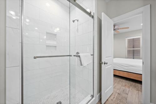 a bathroom with a shower with a glass door at Hammock Dunes J by Youngs Suncoast in Orange Beach