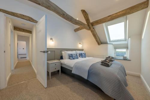 a bedroom with a large bed and two windows at Melin-Bennar in Dyffryn