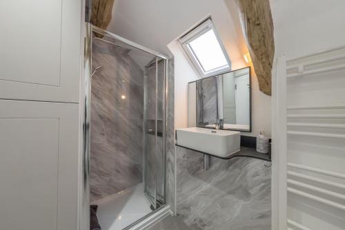 a bathroom with a sink and a glass shower at Melin-Bennar in Dyffryn
