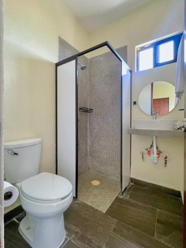 a bathroom with a toilet and a shower and a sink at REGMAR Progreso Yucatán in Progreso