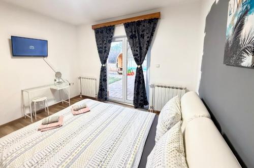 a bedroom with a bed and a window at Holiday home Melani - with private heated pool and sauna in Sinac