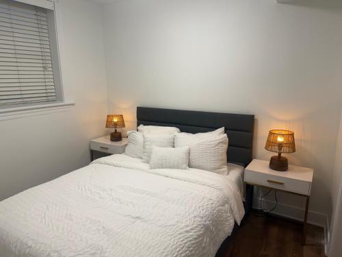 a bedroom with a white bed with two night stands at The Lyons' Lair in Chicago