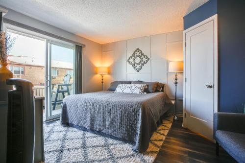 a bedroom with a bed and a balcony at Steps to Brigantine Beach: New Jersey Beach Condo in Brigantine