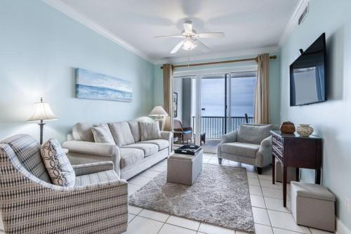 a living room with two couches and a television at Island Royale 1004 by Youngs Suncoast in Gulf Shores