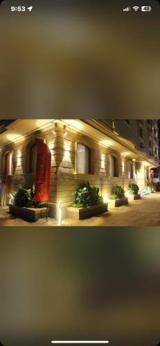 a building with lights on the side of it at Khufu pyramids boutique hotel in ‘Ezbet `Abd el-Ḥamîd