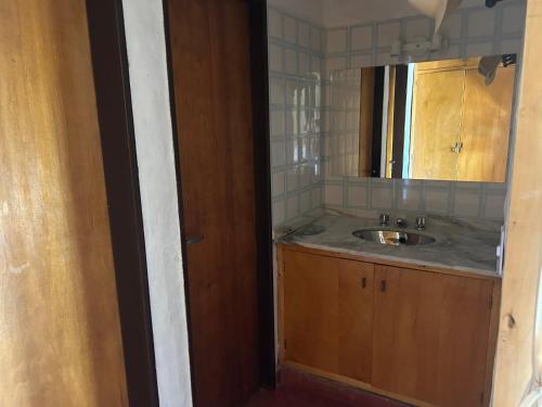 a bathroom with a sink and a mirror at Chalet Doña Ines in Cuesta Blanca
