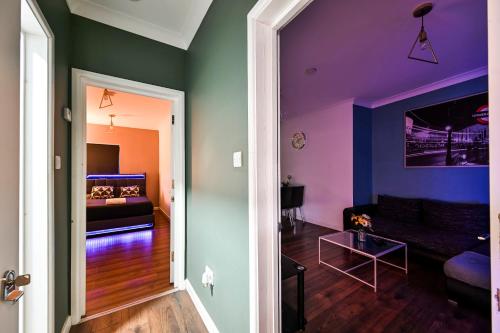 a living room with a couch and a bed at Beautiful Modern Apartment on Wick Lane in London