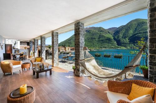 a living room with a hammock and a view of a lake at La Torre Di Porlezza in Porlezza