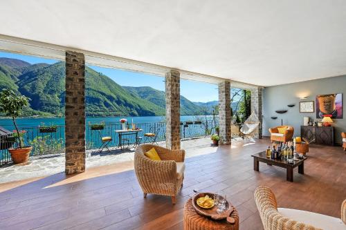 a living room with a view of a lake and mountains at La Torre Di Porlezza in Porlezza