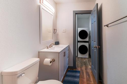 a bathroom with a toilet and a sink and a mirror at FIFA World Cup - Stylish 2 BR 1 Bath home with fenced yard near AT&T Stadium, Globe Life, Six Flags & More in Arlington