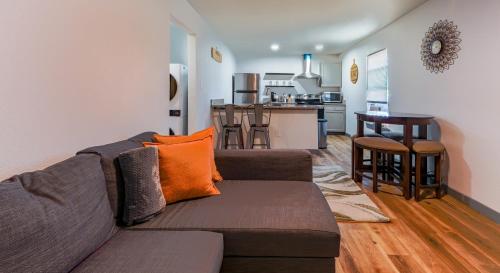 a living room with a couch and a kitchen at FIFA World Cup - Stylish 2 BR 1 Bath home with fenced yard near AT&T Stadium, Globe Life, Six Flags & More in Arlington