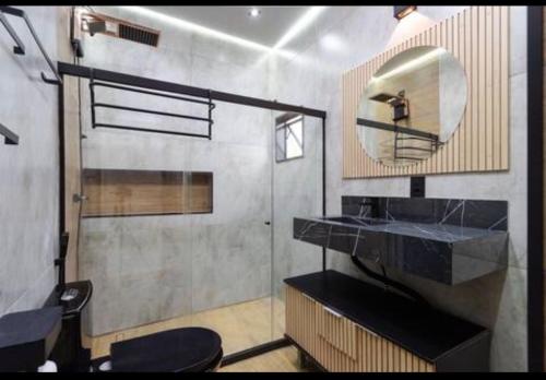 a bathroom with a sink and a mirror at Espaço do Imperador in Petrópolis