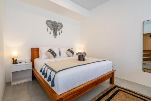 a bedroom with a large bed in a room at Manik Tropicana Loft in Canggu