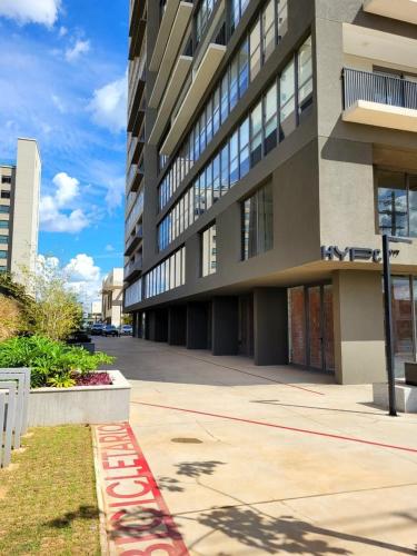 a large building with a sidewalk in front of it at Condomínio Residencial - Hype 017 | by Housi in Sao Jose do Rio Preto