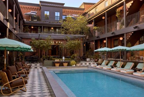 a hotel pool with lounge chairs and umbrellas at Hotel Anna & Bel in Philadelphia