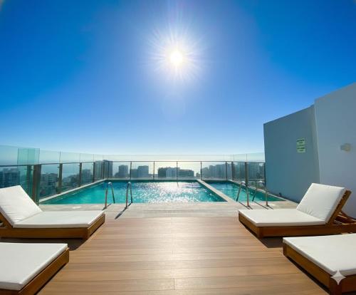 a swimming pool on top of a building at Barranco Modern Apartments with Rooftop Pool by Geko in Lima