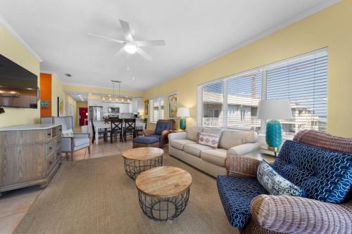 a living room with a couch and chairs and a kitchen at Marlin Key 4G by Youngs Suncoast in Orange Beach