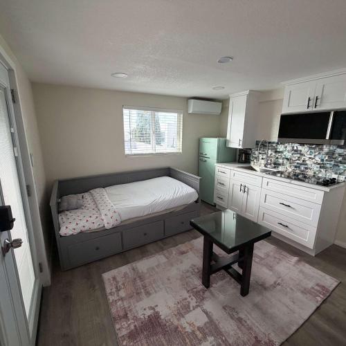a small bedroom with a bed and a kitchen at Suite Steps to San Diego Top Spots in San Diego
