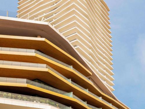 a tall building with balconies on the side of it at Raffles Istanbul in Istanbul