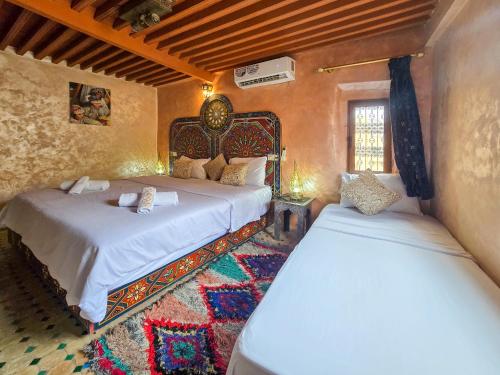 a bedroom with two beds in a room at Riad Fes Hayat - Confort Stay in Fez