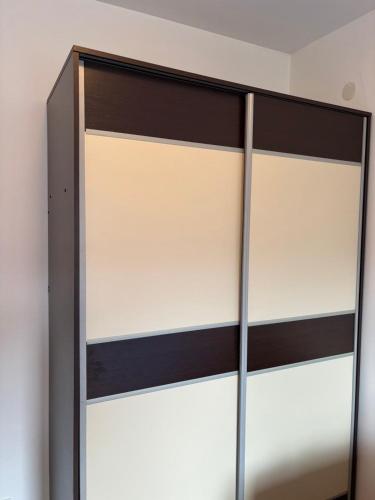 a closet with black and white sliding doors at Kolasin Rent Apartment in Kolašin