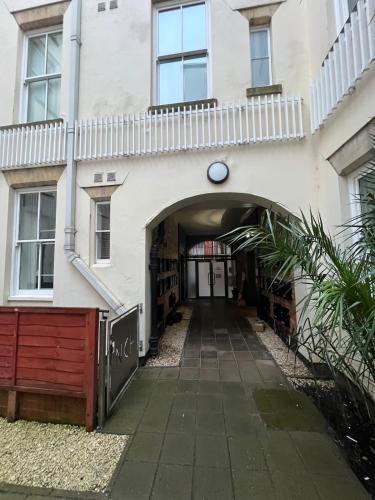 an entrance to a white building with an archway at New & Modern 2-Bed Flat in City Centre in Nottingham