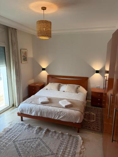 a bedroom with a bed with two pillows on it at Casaflor Tunis in Tunis