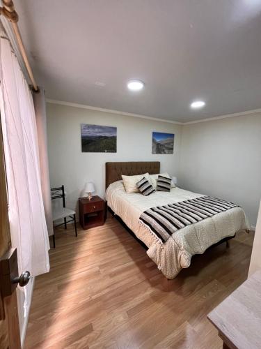 a bedroom with a bed and a wooden floor at Nueva Carrera in Illapel