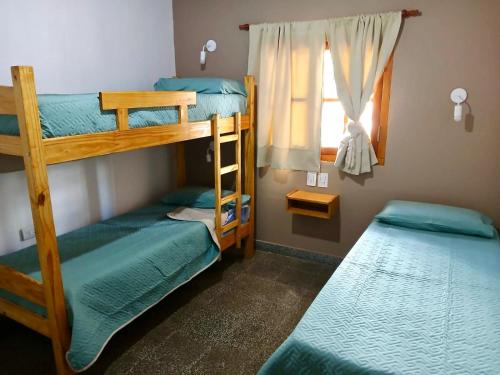 two bunk beds in a room with a window at Casa Josefa Cafayate in Cafayate