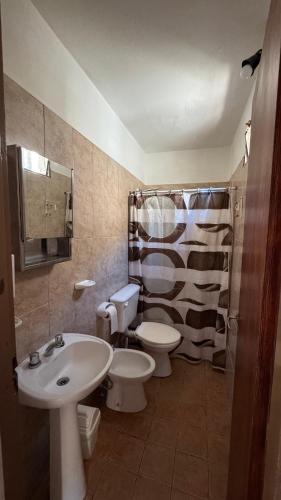a bathroom with two toilets and a sink and a shower at LA FACUNDA in San Francisco del Monte de Oro