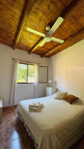 a bedroom with a bed with a ceiling fan at LA FACUNDA in San Francisco del Monte de Oro