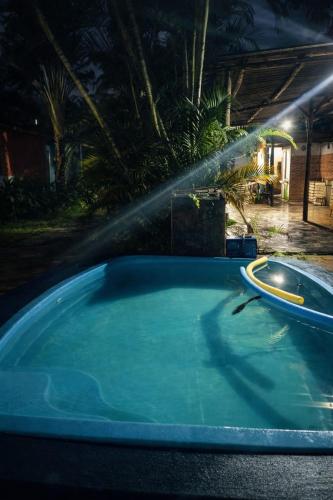 a hot tub with a sprinkler in a yard at Pousada Rancho in Angra dos Reis