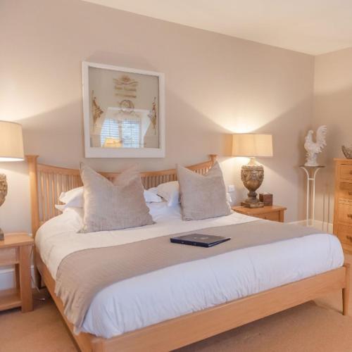 a bedroom with a bed with a laptop on it at The Bell at Hampton Poyle in Kidlington