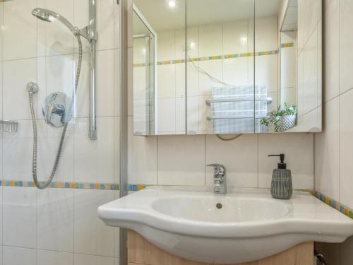 a bathroom with a sink and a shower at Chalet Pölven in Schwoich