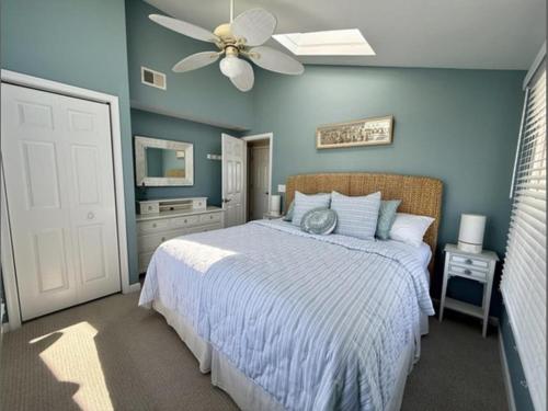a bedroom with a bed and a ceiling fan at Second Floor Oceanfront Unit in Brant Beach