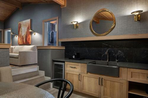 a kitchen with a sink and a mirror at Red Cliffs Lodge Moab in Castle Valley