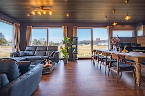 a living room with a couch and a table at The Horizon Residence in Makubetsu
