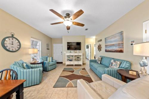 a living room with a couch and a ceiling fan at Orange Beach Villas - Casa Bella by Youngs Suncoast in Orange Beach