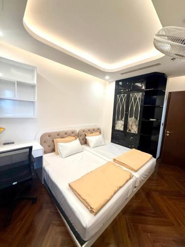 a bedroom with a large white bed in a room at Hanaco Homestay in Hai Phong