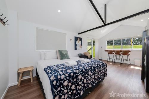 a bedroom with a bed with a blue and white bedspread at The Hideaway in Emu Park